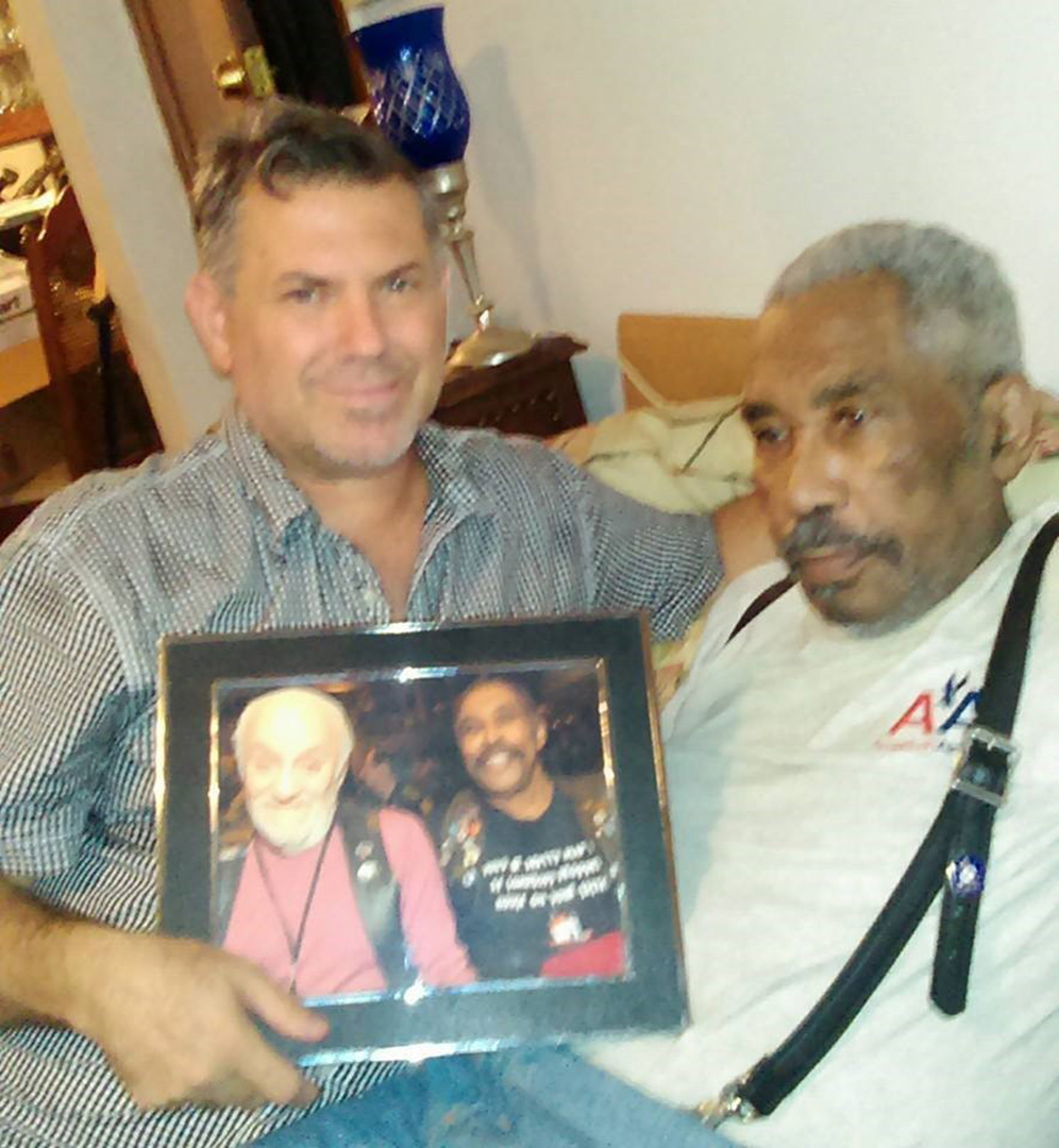 Sir Vern and Jose Gutierrez holding an historic photo of Mr. Marcus Hernandez and Sir Vern Stewart.